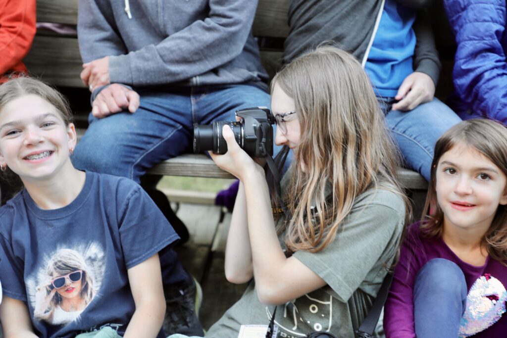 Girl taking picture of another girl with camera