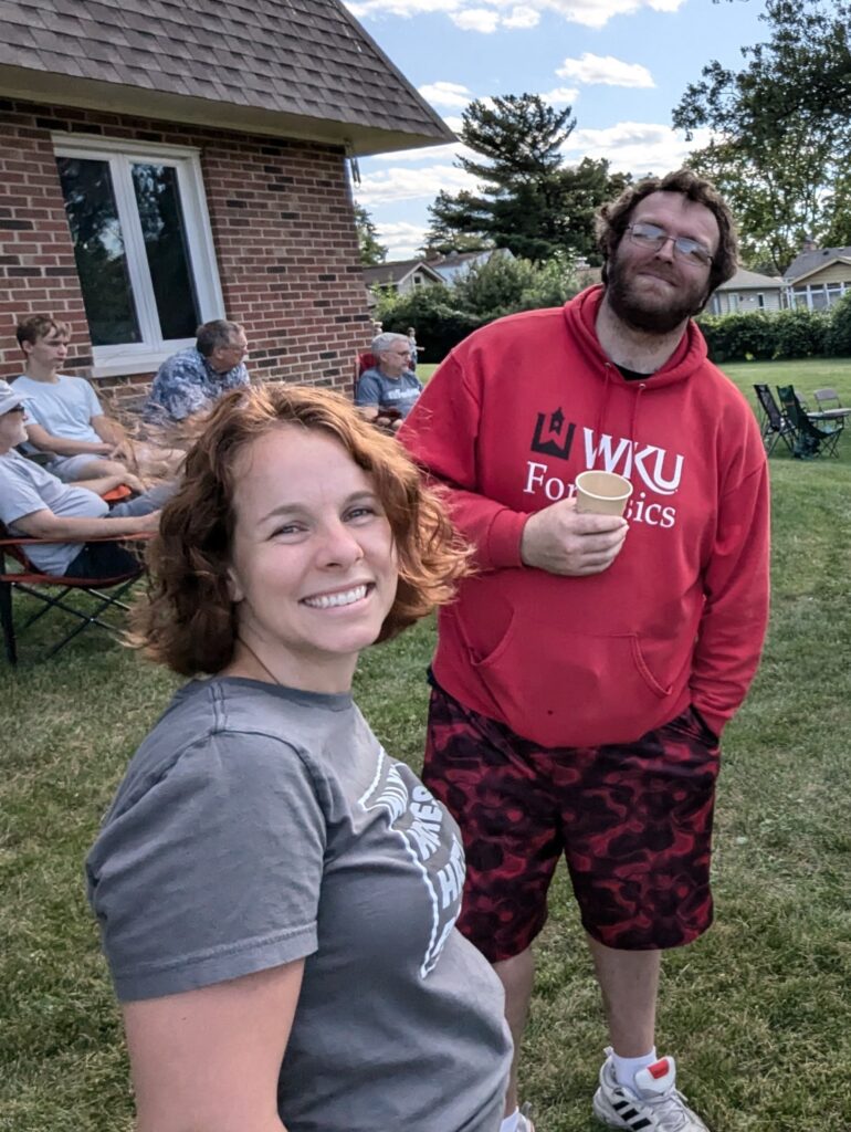 Smiling man and woman standing outside