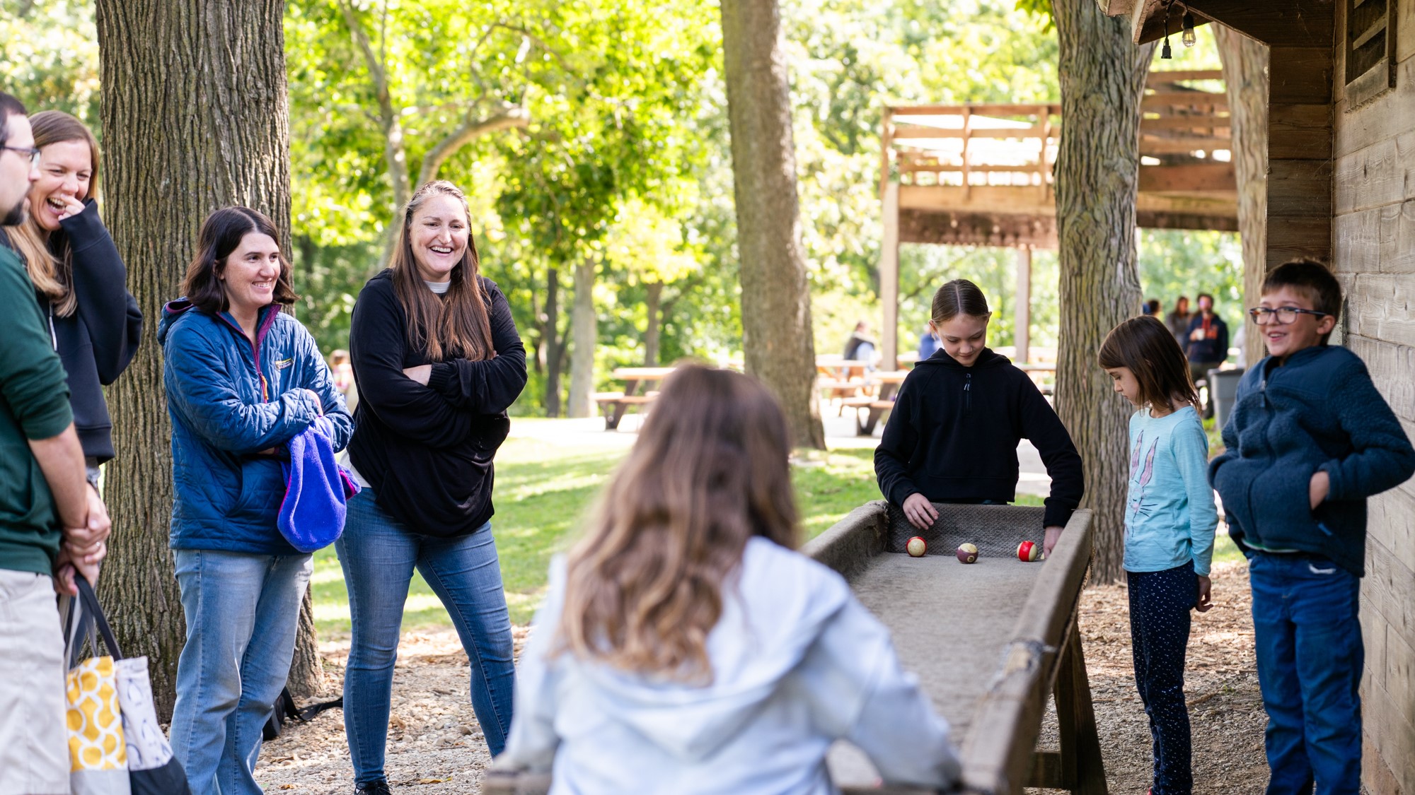 Group of adults and children laughing in nature