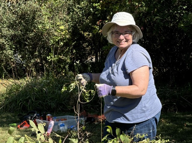 Smiling woman does yard work 