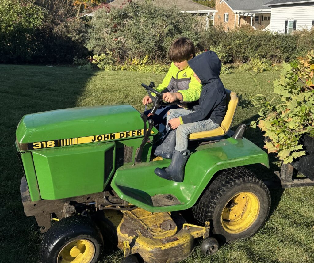 Child driving small tractor