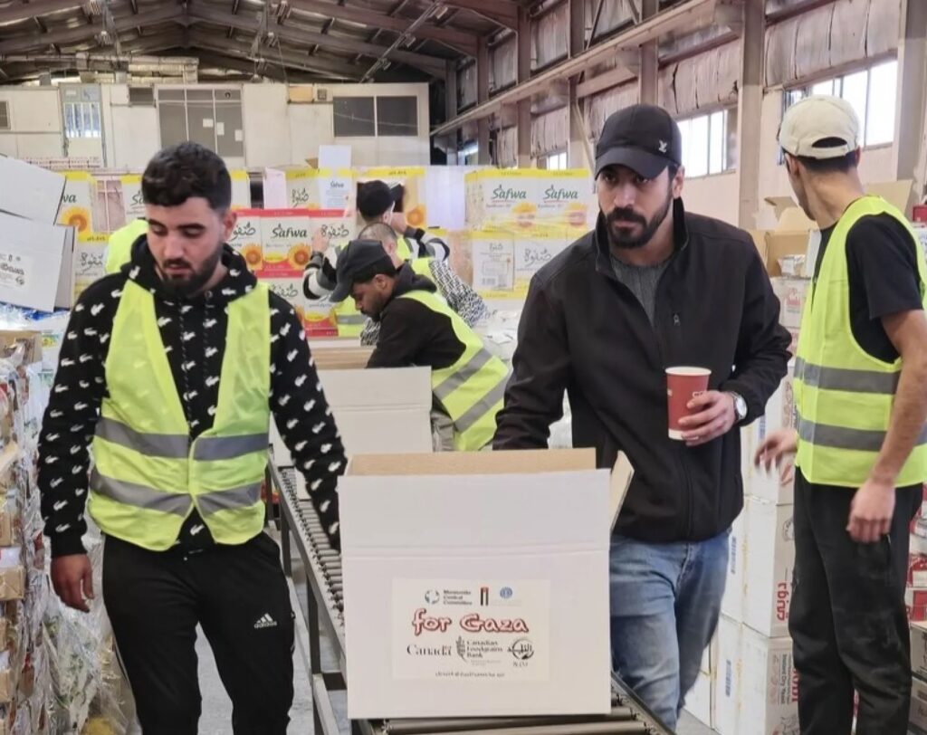 Group of men pack boxes for Gaza relief