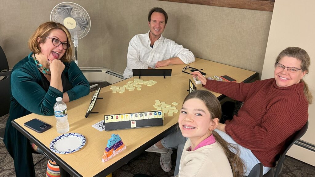 Three adults and a teenager playing a game