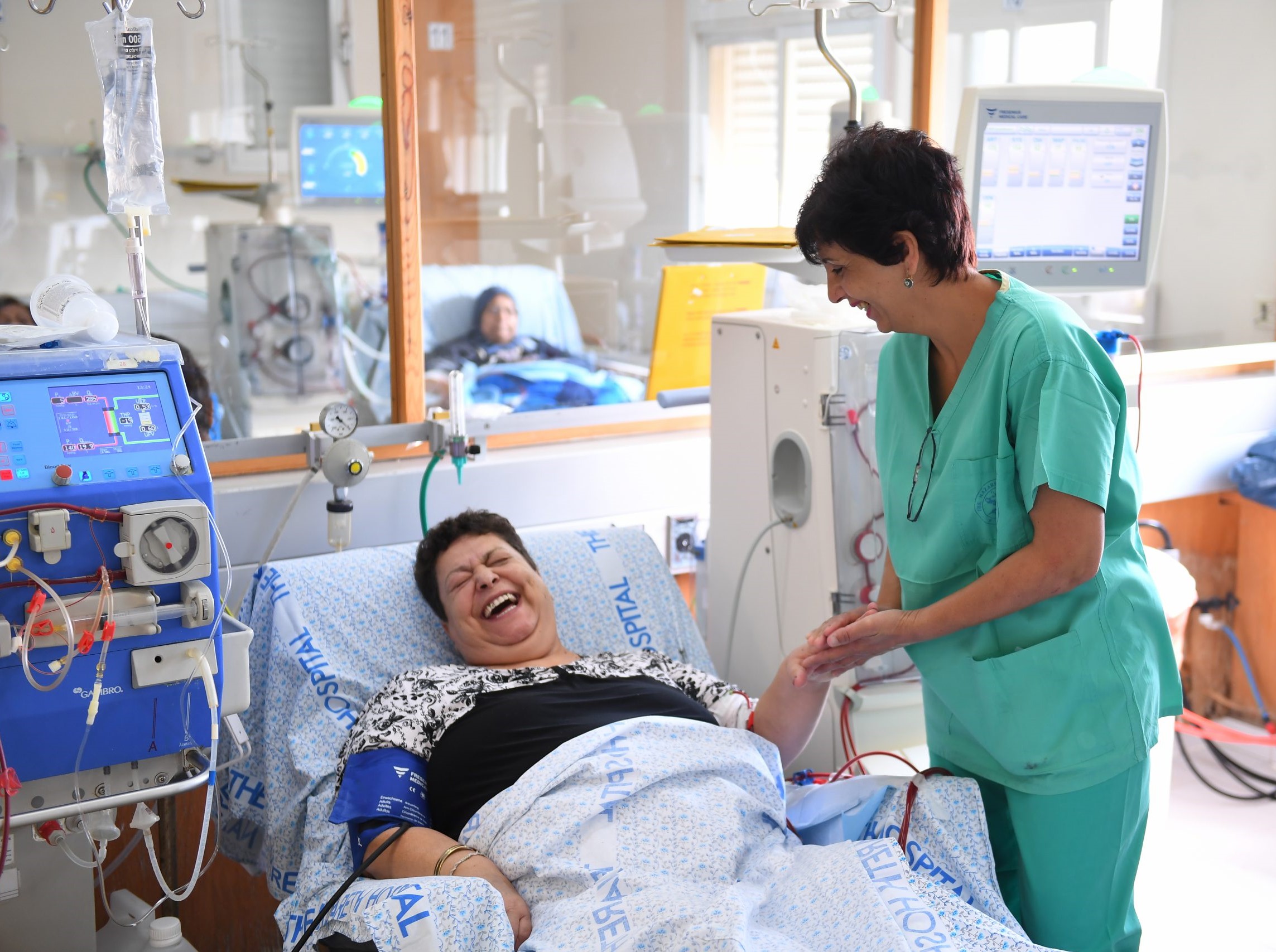 Women and nurse smiling in a hospital