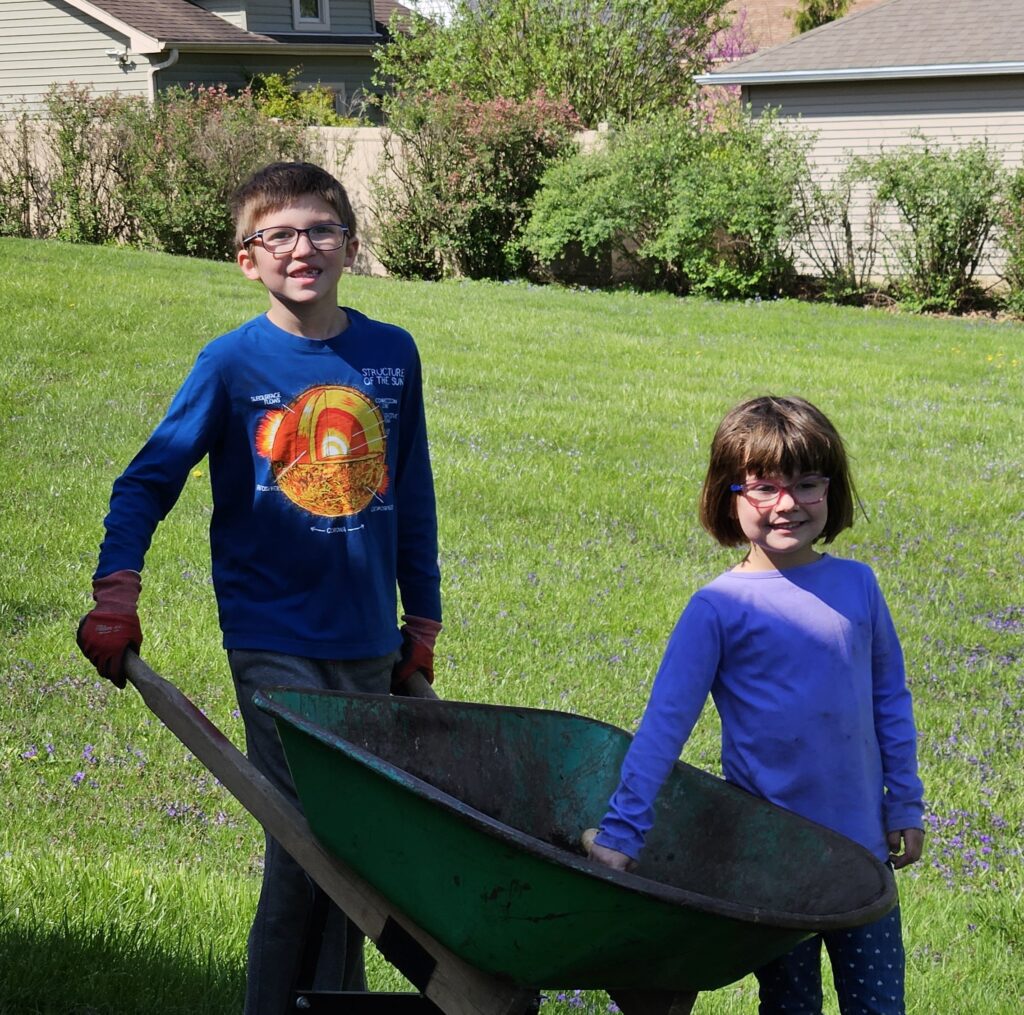 Boy and girl with a wheelbarrow