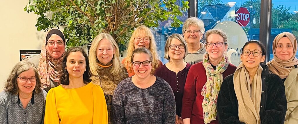 Group of smiling women of different cultural backgrounds inside a coffee shop