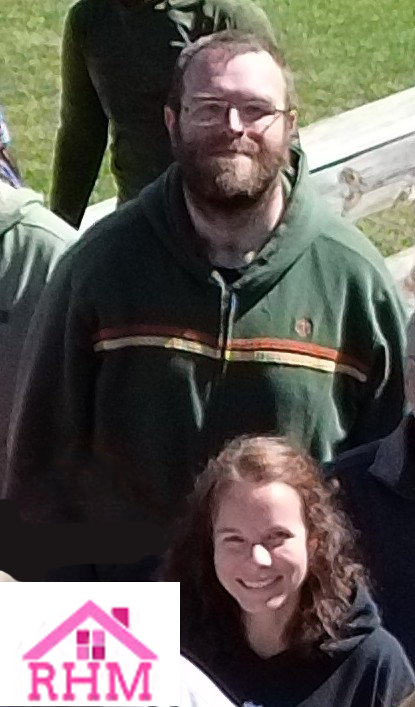 Smiling man and woman outside.