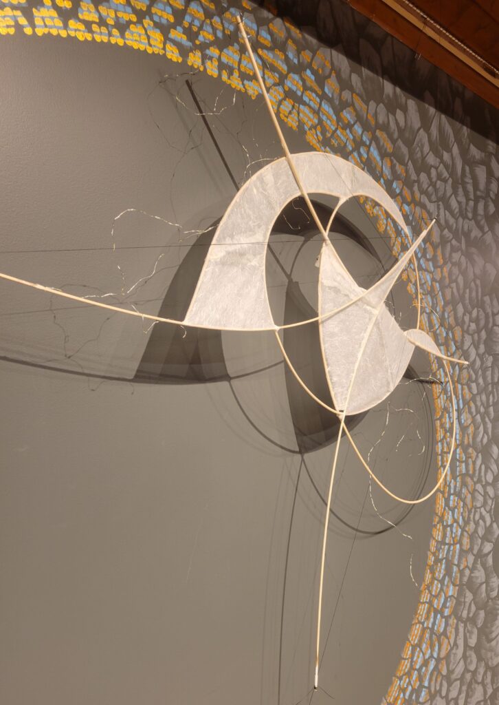 An abstract star hanging in the front of a sanctuary.