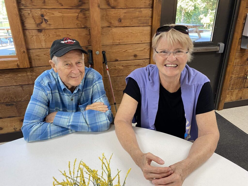 Smiling older couple inside a lodge.