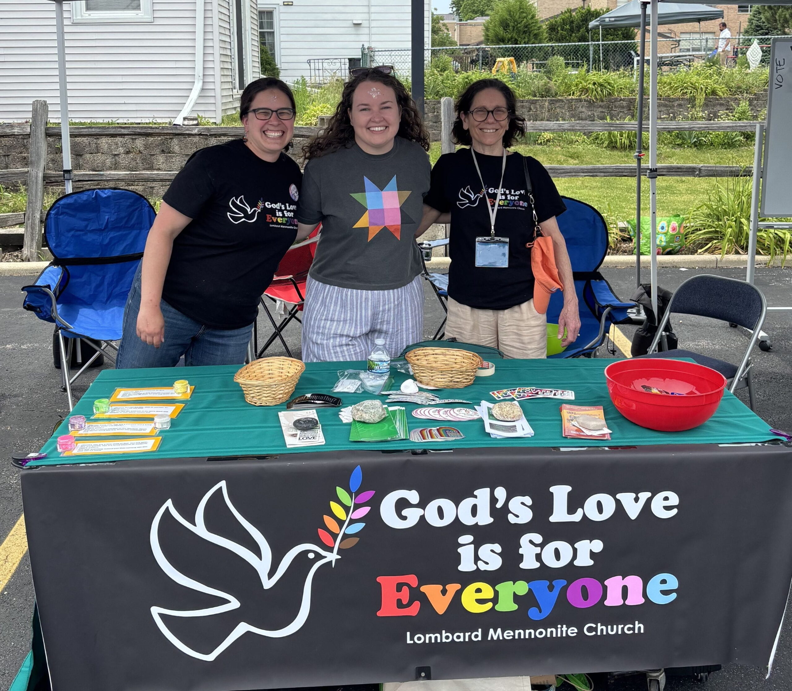 welcoming statement (1) table at lombard pride event saying God's love is for everyone